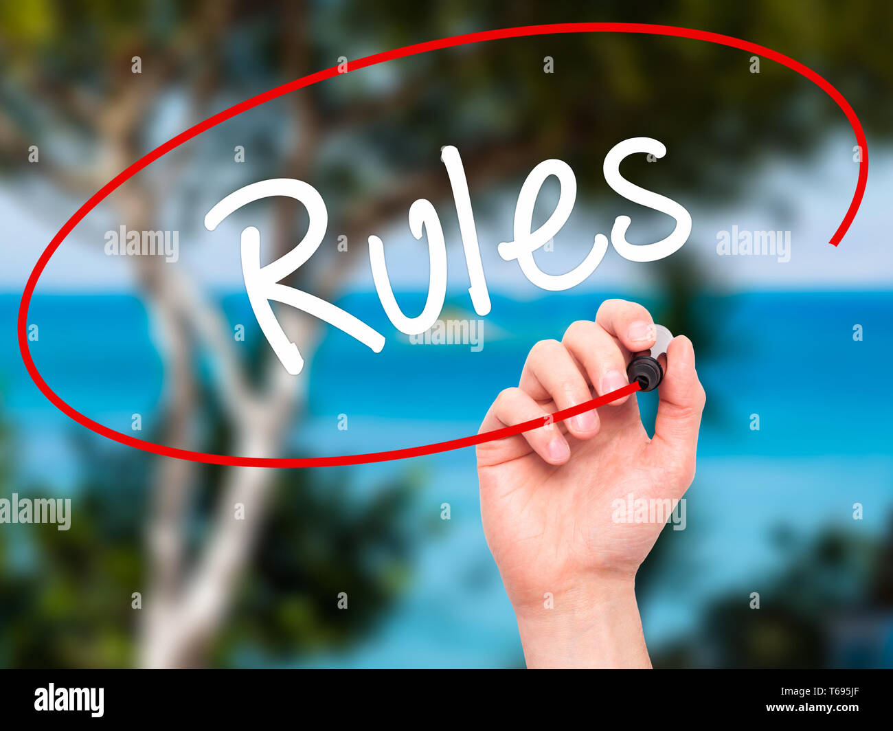 Man Hand writing Rules with black marker on visual screen. Stock Photo