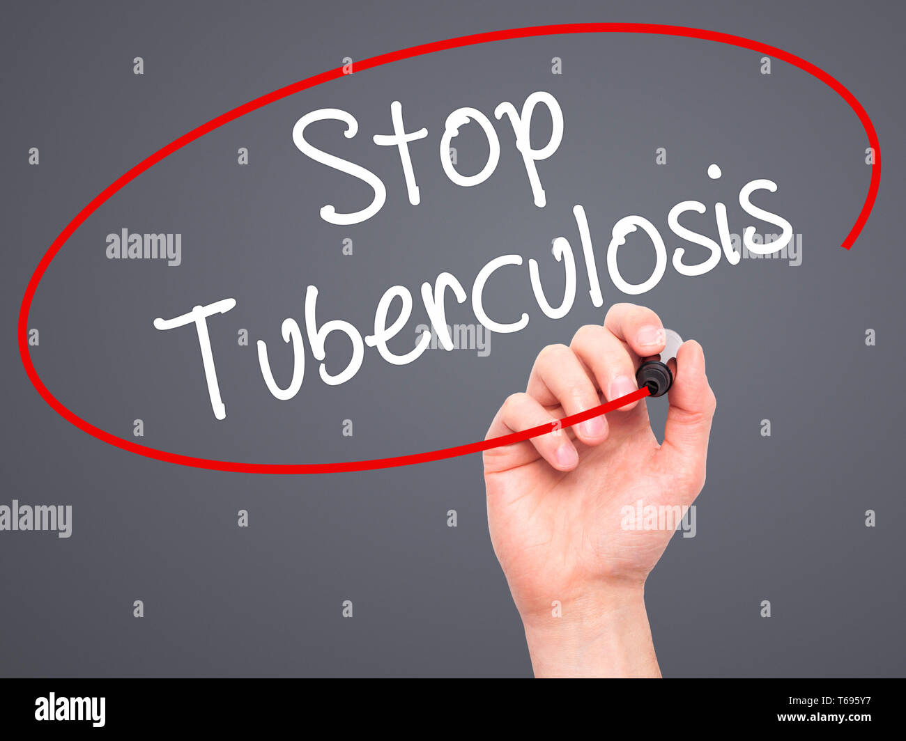 Man Hand writing Stop Tuberculosis with black marker on visual screen. Stock Photo
