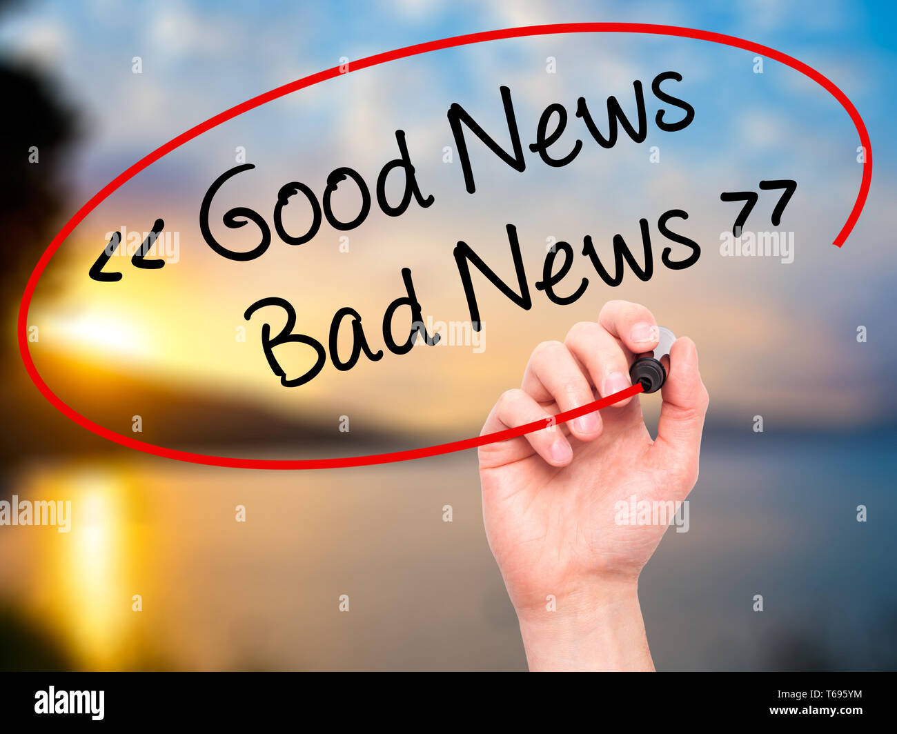 Man Hand writing Good News - Bad News with black marker on visual screen. Stock Photo