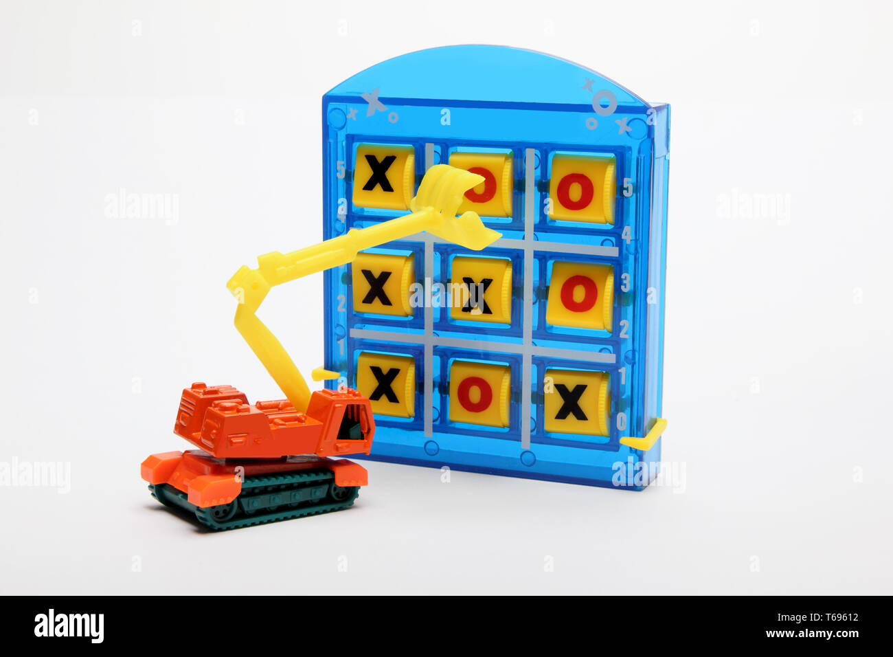 Tic Tac Toe and Toy Earthmover on White Background Stock Photo