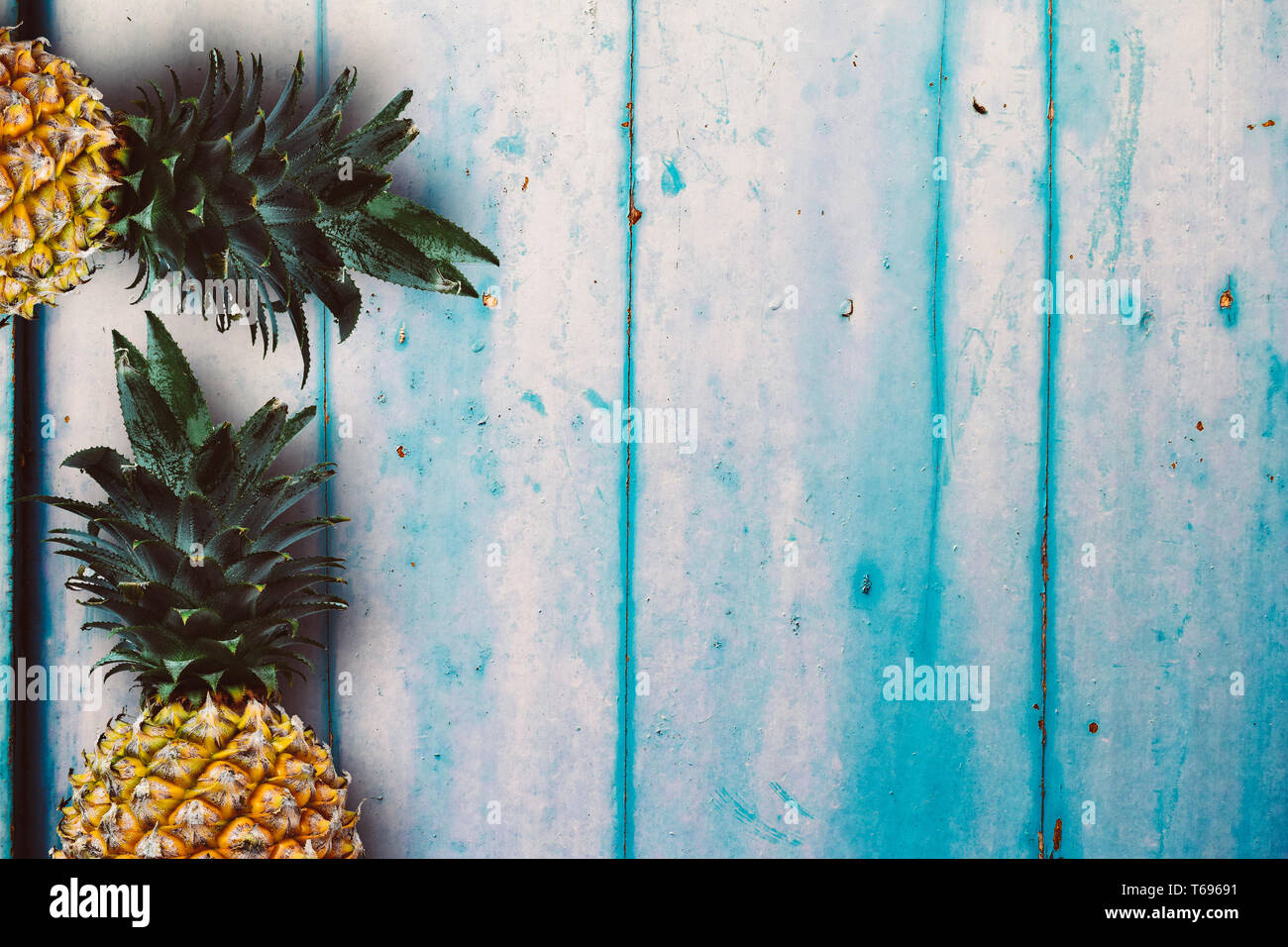 Ripe yellow pineapple over the rustic wooden table Stock Photo