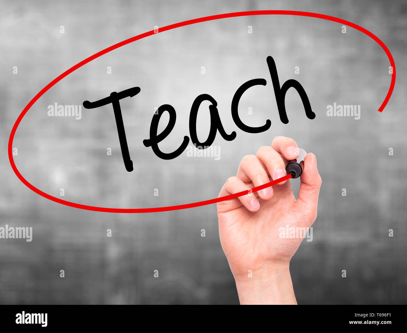 Man Hand writing Teach with black marker on visual screen Stock Photo ...