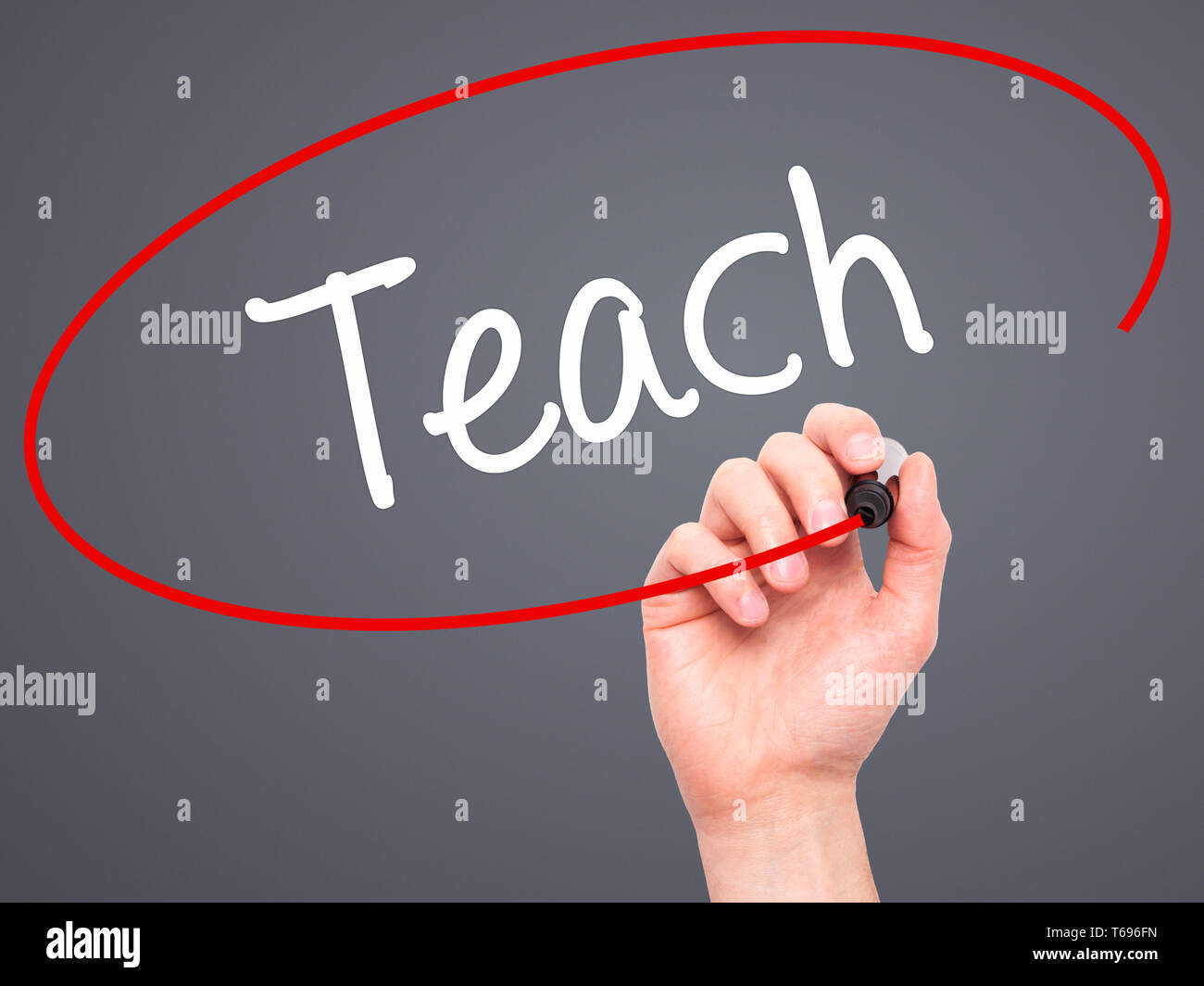 Man Hand writing Teach with black marker on visual screen Stock Photo ...