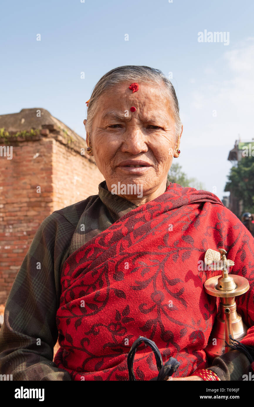 Bhaktapur, Kathmandu Valley / Nepal - April 17th, 2019 - Nepali New Year celebrations showing elderly woman at Durbar Square. Stock Photo