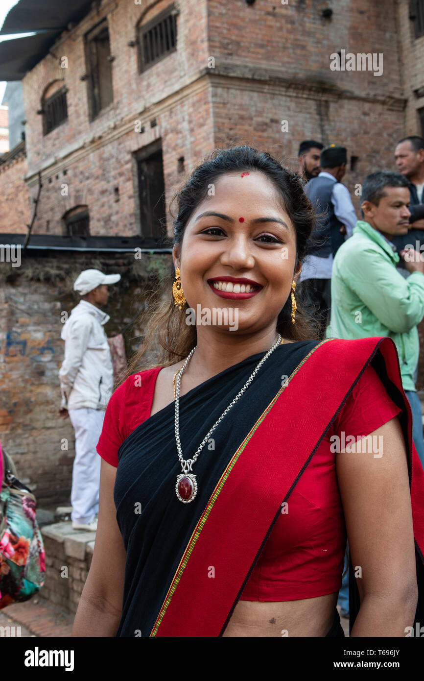 Bhaktapur, Kathmandu Valley / Nepal - April 17th, 2019 - Nepali New Year celebrations showing 20 to 25 year old woman in the city. Stock Photo