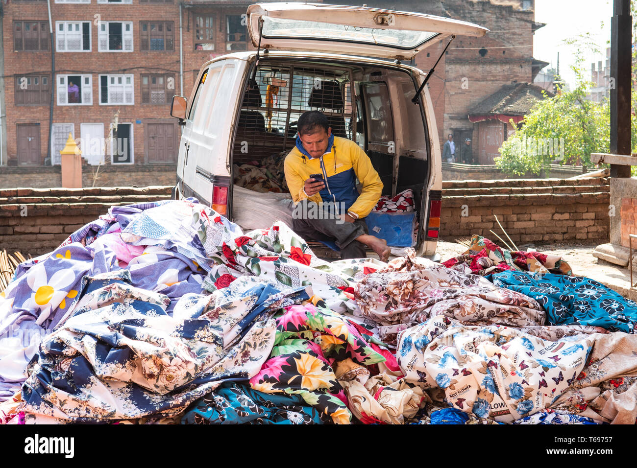 Bhaktapur, Kathmandu Valley / Nepal - April 17th, 2019 - Nepali man selling fabrics in the city. Stock Photo