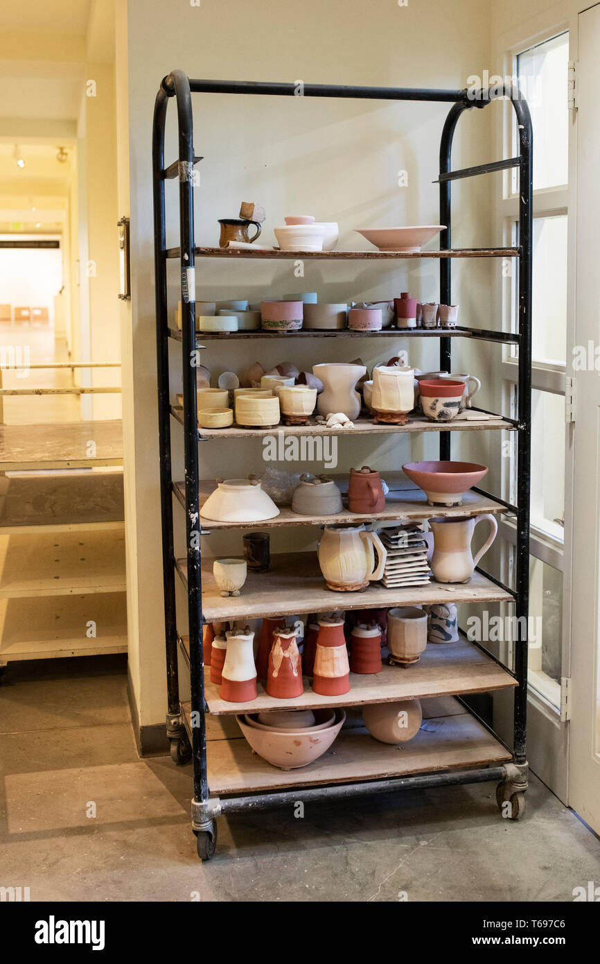 A rack of pottery and ceramics student projects at the Indianapolis Arts Center, an art school and gallery in Indianapolis, Indiana, USA. Stock Photo