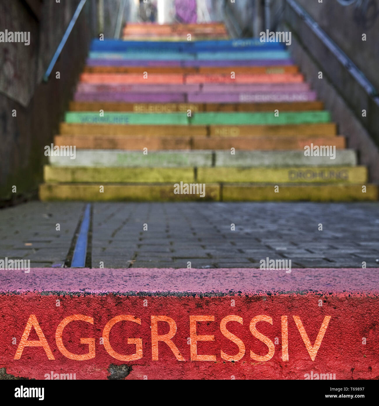 the word aggressive on colourful perron, Scala, Holsteiner Treppe, Wuppertal, Germany Stock Photo