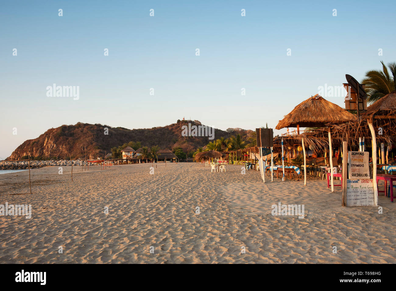Simple beach with eateries with plastic chairs. Chacahua National Park, Oaxaca State, Mexico. Apr 2019 Stock Photo