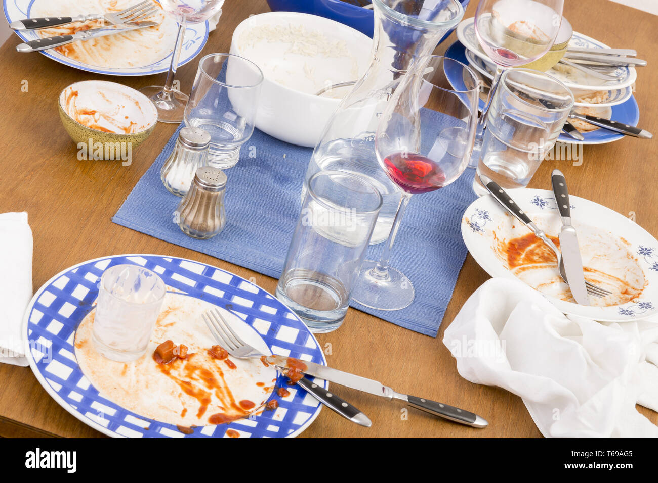 Table with several dirty dishes arranged on it Stock Photo - Alamy
