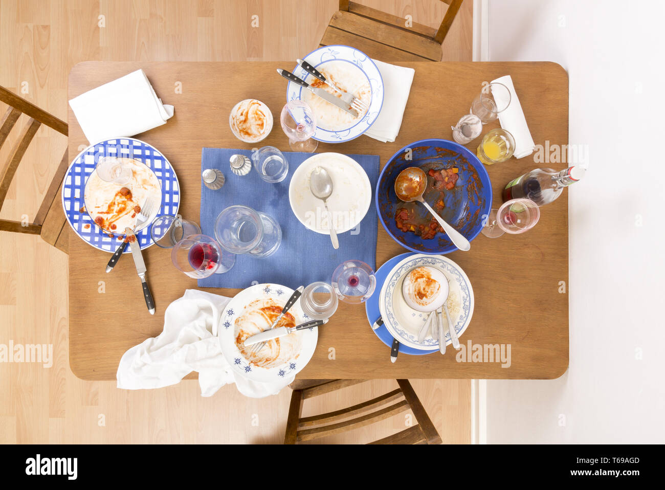 Table with chairs and dirty dishes arranged on it Stock Photo Alamy