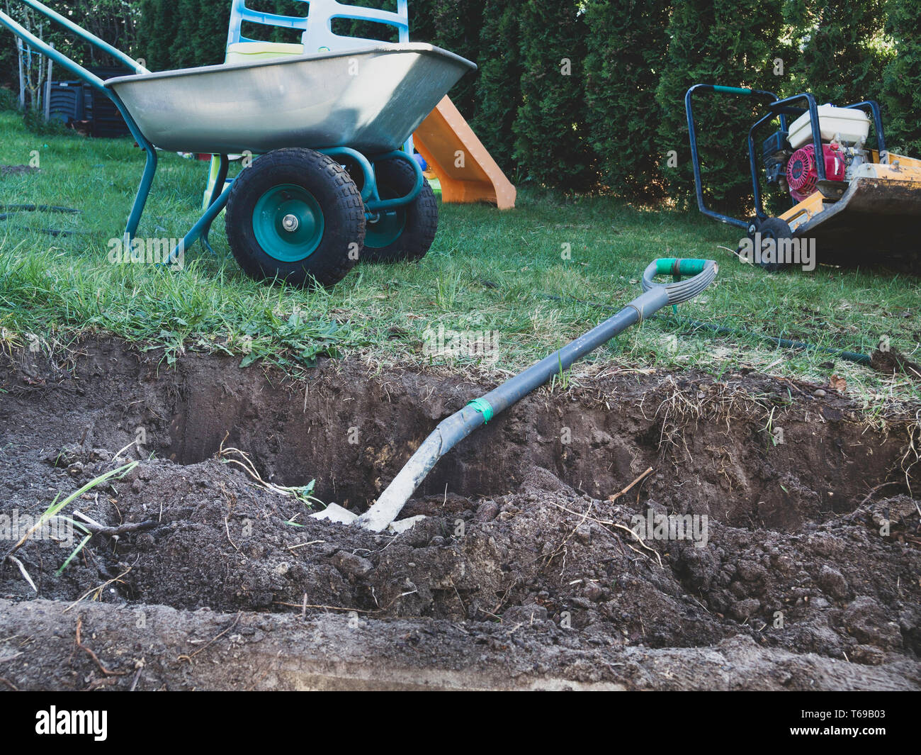 Wheelbarrow Machine Example wheel barrow on the land and shovel, tamping machine, gardening concept ...