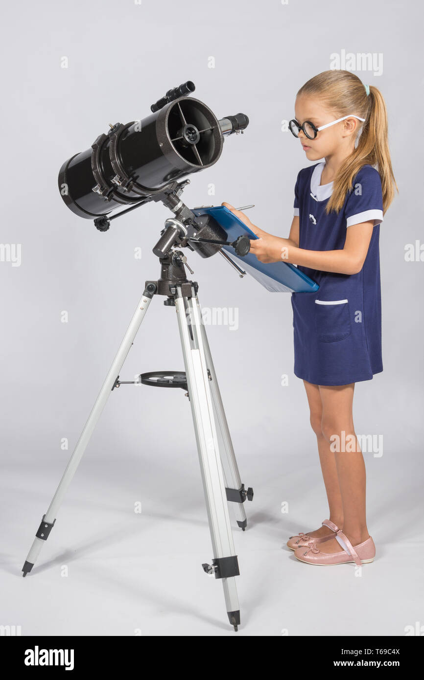The young astronomer with glasses writes observations Stock Photo