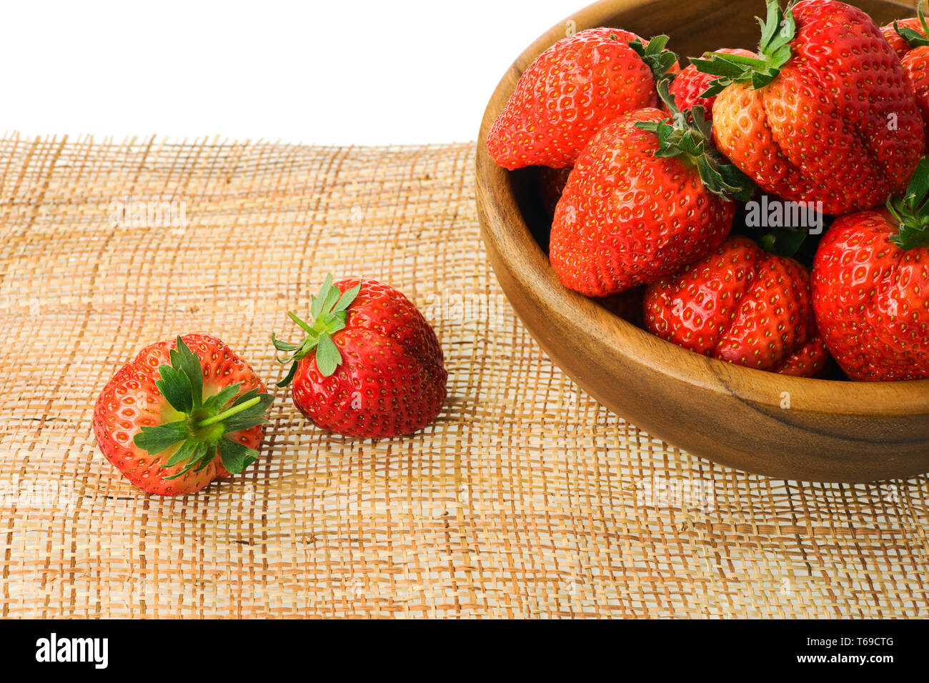 Fresh ripe strawberries in wooden bowl isolated on white background ...