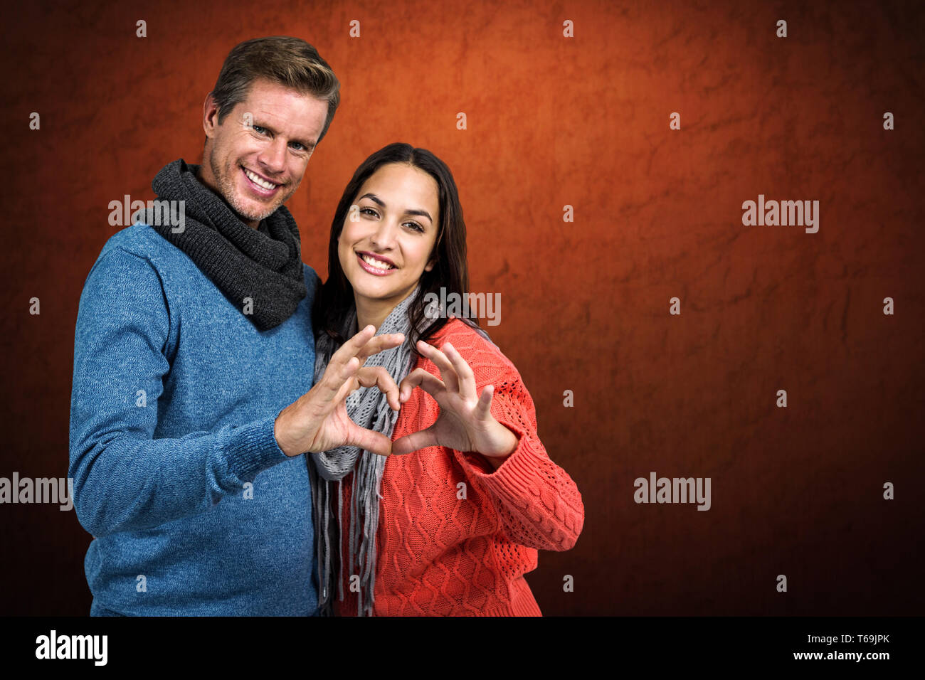 Composite image of portrait of couple making heart shape with hands ...