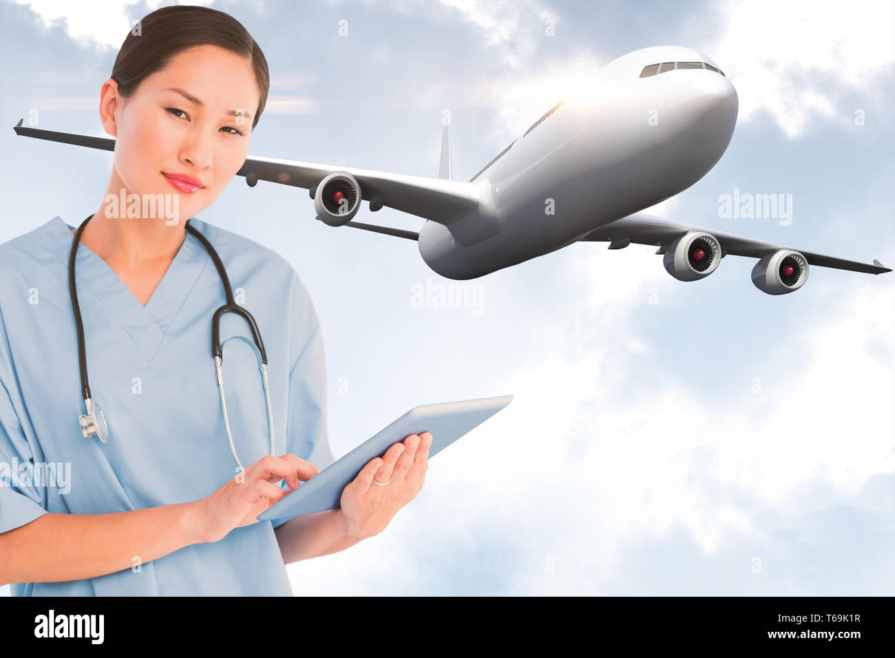 Composite image of surgeon using digital tablet with group around table in hospital Stock Photo