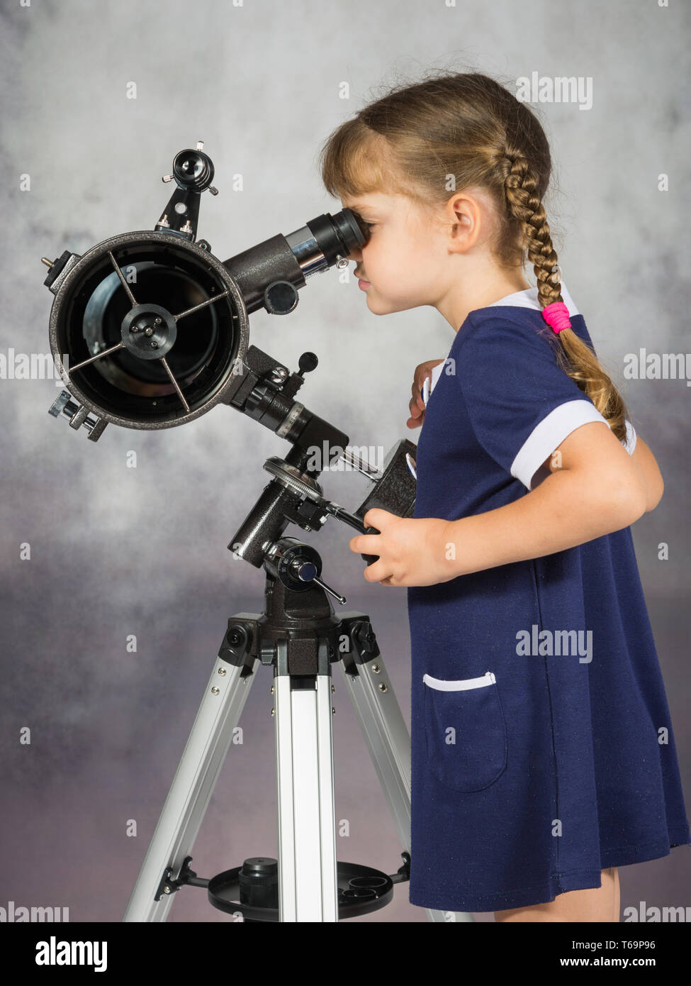 Girl amateur astronomers looking into the telescope eyepiece Stock Photo