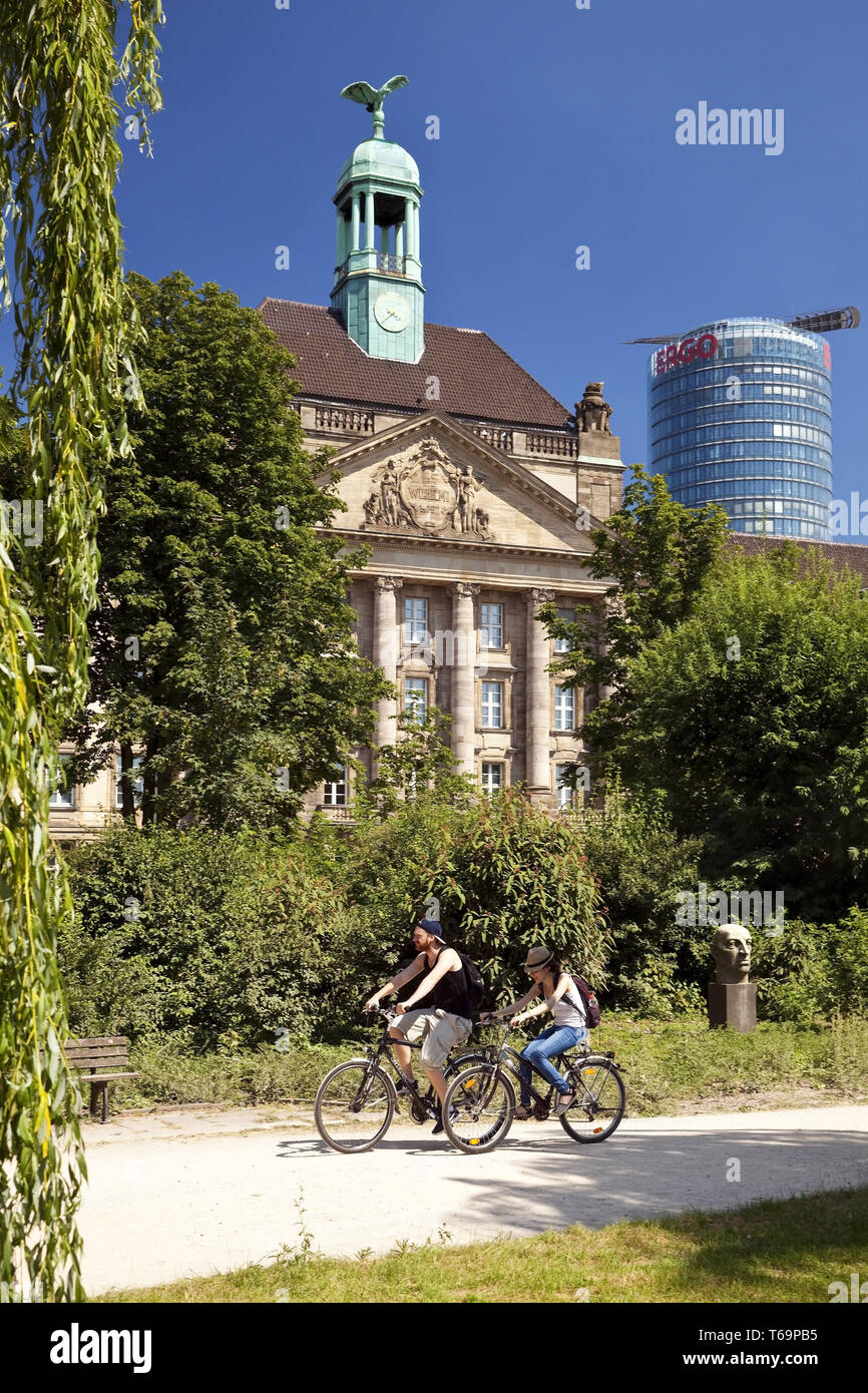 two cyclist in front of the legislature building and the Ergo office tower, Duesseldorf, Germany Stock Photo