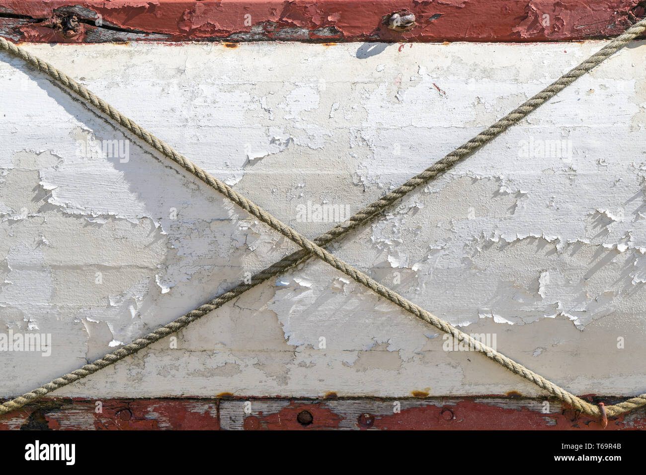 Old planks with a crossed rope Stock Photo - Alamy