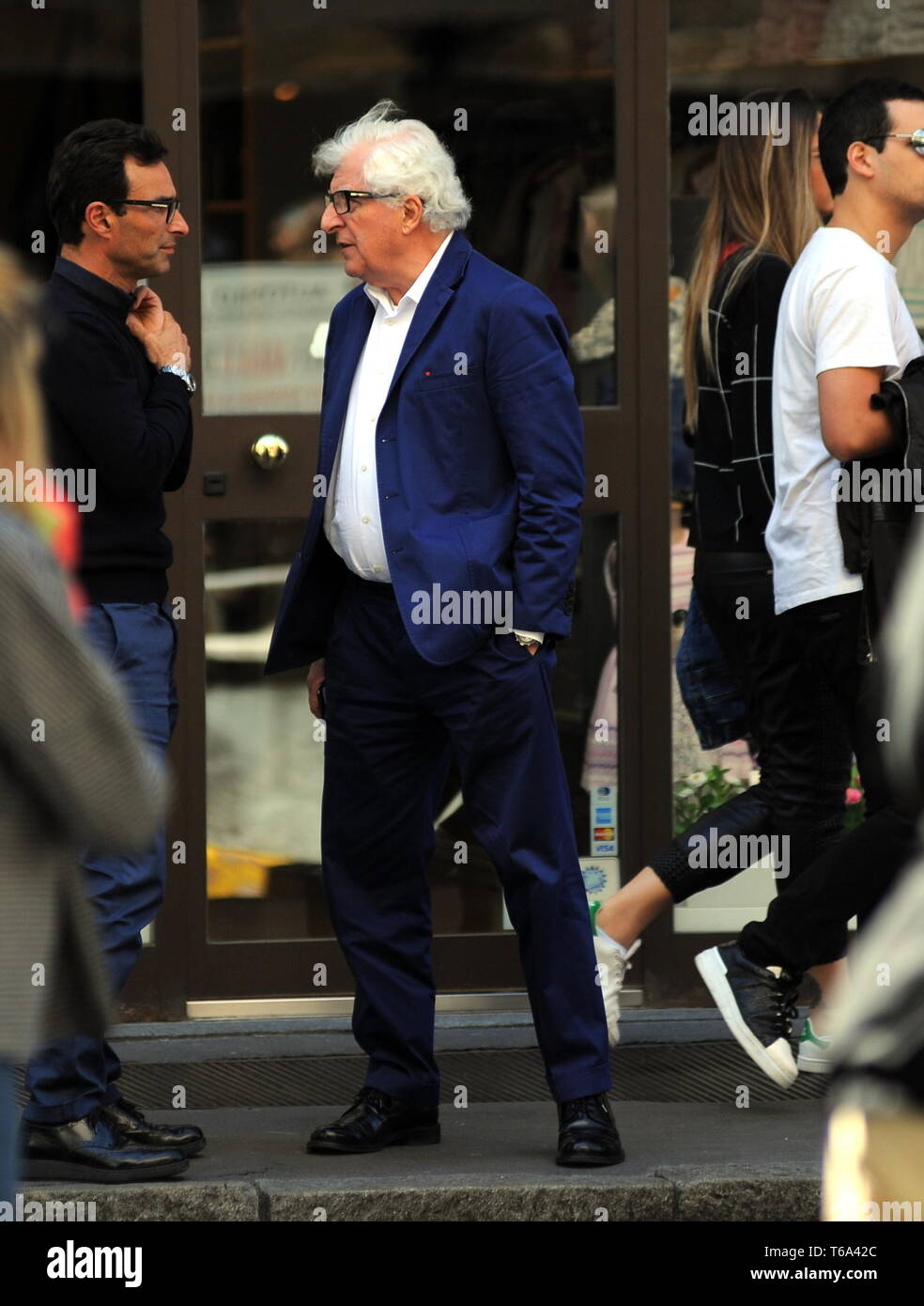 Milan, Patrizio Bertelli in the center Patrizio Bertelli, the patron of the  "Prada" brand together with his wife Miuccia, surprised at the exit of the  restaurant while talking to a friend, then