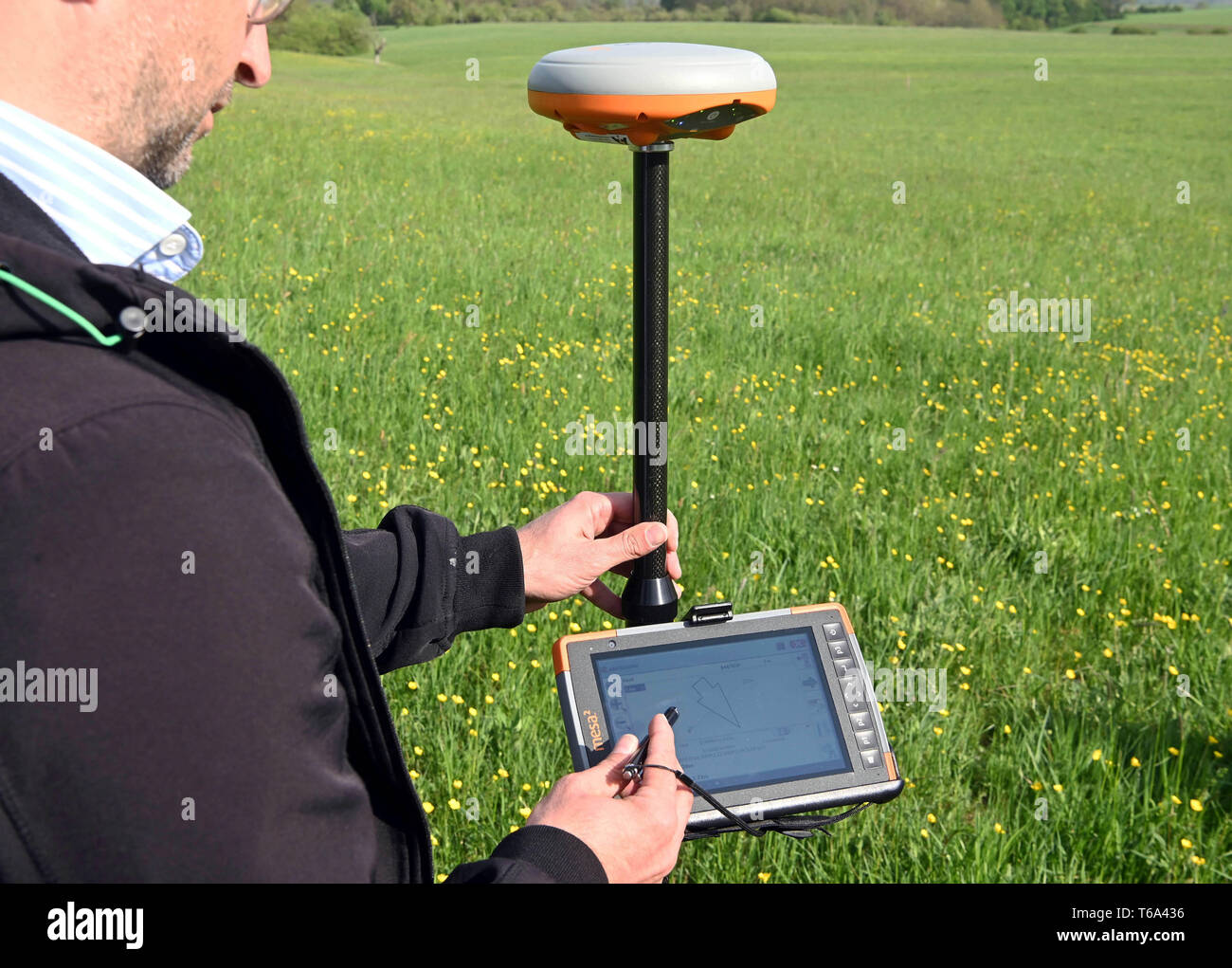 Maulbronn, Germany. 30th Apr, 2019. Using a GPS surveying device, part of the monitoring for mapping the meadows is carried out at a mowing meadow. The state government is worried about the state of the blooming mowing meadows in the country. During a visit to the Enzkreis, Environment Minister Untersteller spoke of problem children. One third of the ecologically valuable mowing meadows are in poor condition. The meadows are characterized by a great variety of species, are little or no fertilized and rarely mowed. Credit: Uli Deck/dpa/Alamy Live News Stock Photo