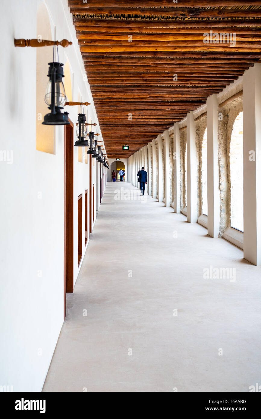Portrait photo of a series of kerosene lamp in one of the open-air corridor forming a one point perspective in the Qasr Al-Hosn Fort in Abu Dhabi, Uni Stock Photo