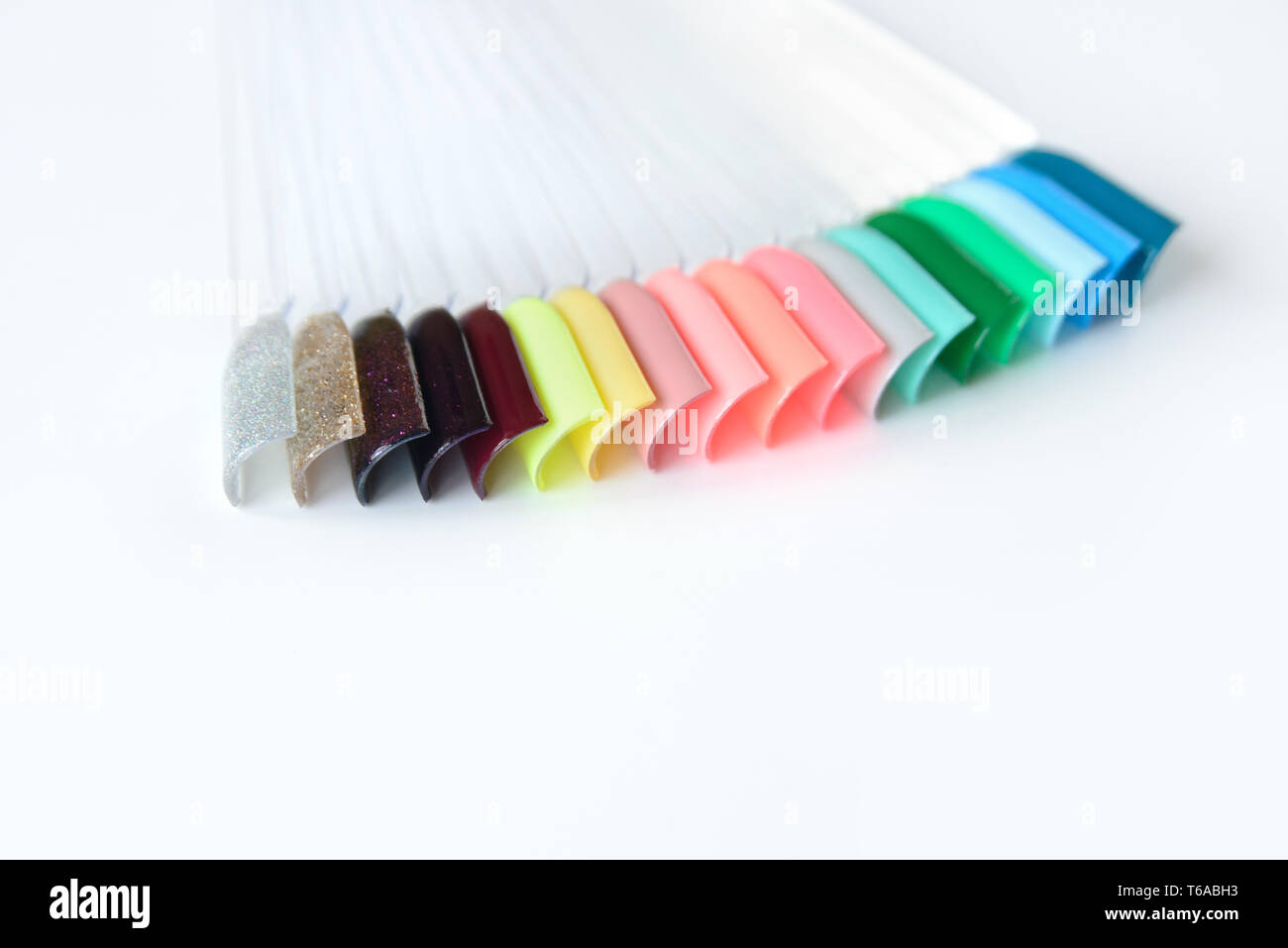 Nail polish samples in different bright colors. Colorful nail lacquer manicure swatches. Top view of nail art samples palette. Free copy space. Stock Photo