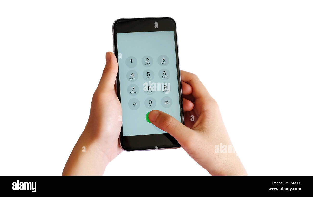 A hand pressing the number pad on the screen display of a smartphone. Stock Photo