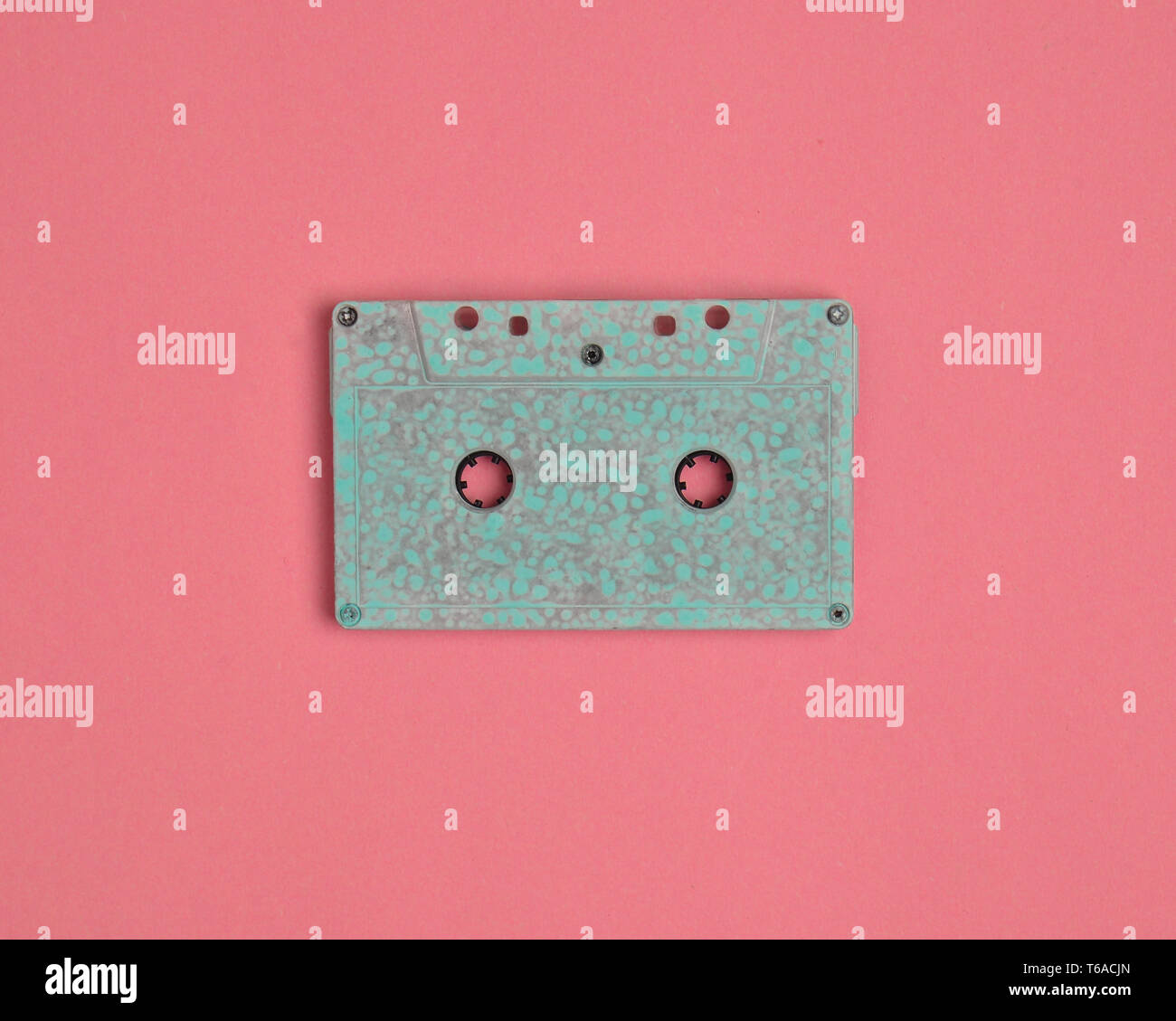 Minimalistic trend of audio technology from the 80s. Audio cassette on pastel color background. Stock Photo