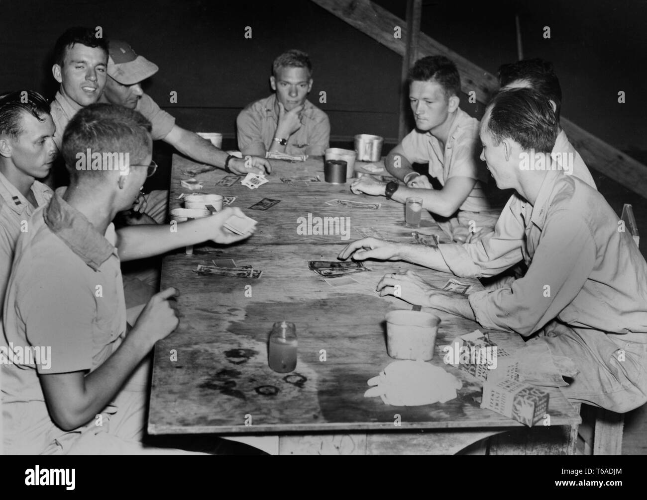 US servicemen play cards on their base in the South Pacific during World War II, ca. 1943. Stock Photo