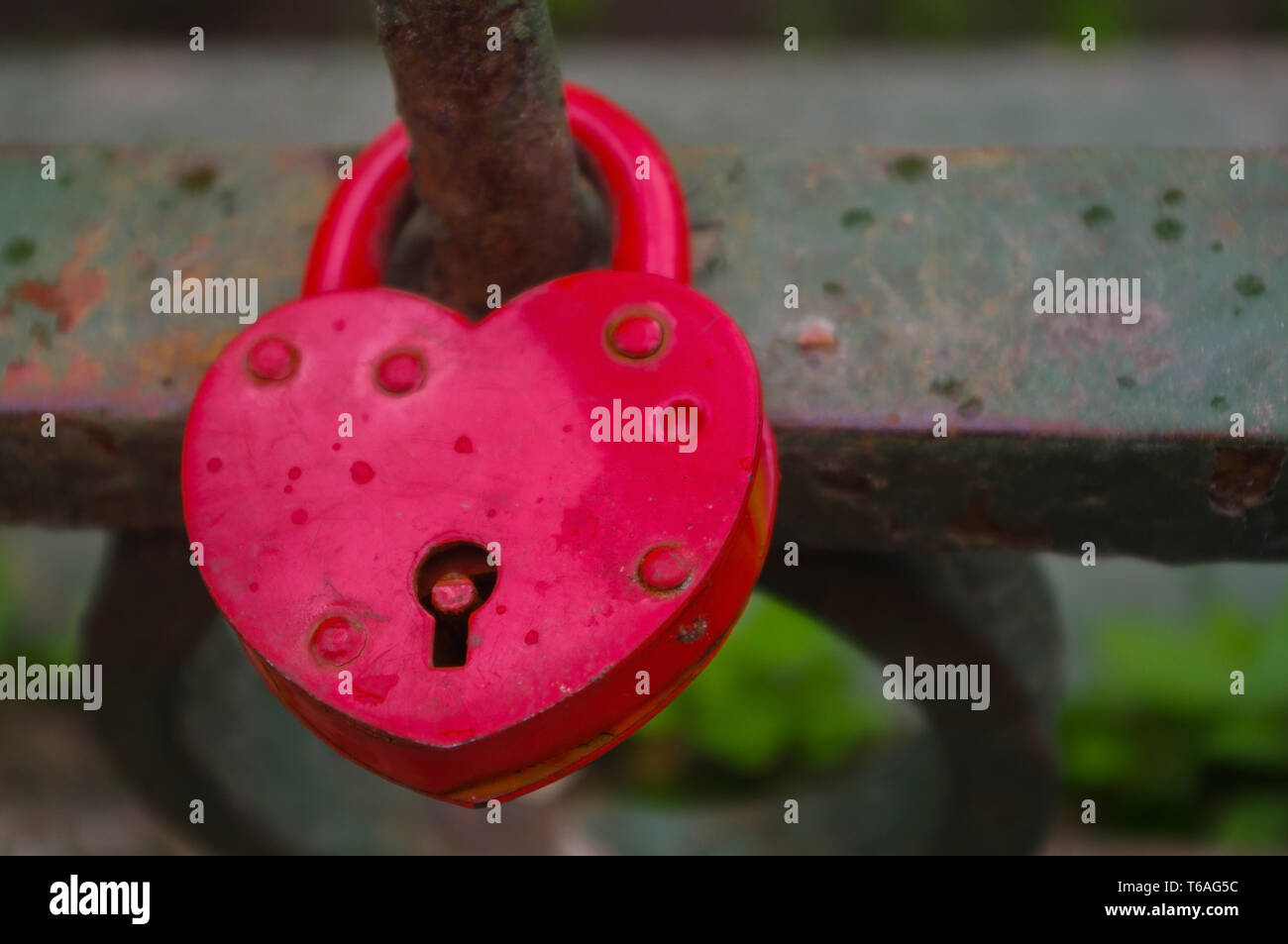 beautiful red heart-shaped padlock locked on iron chain Stock Photo - Alamy