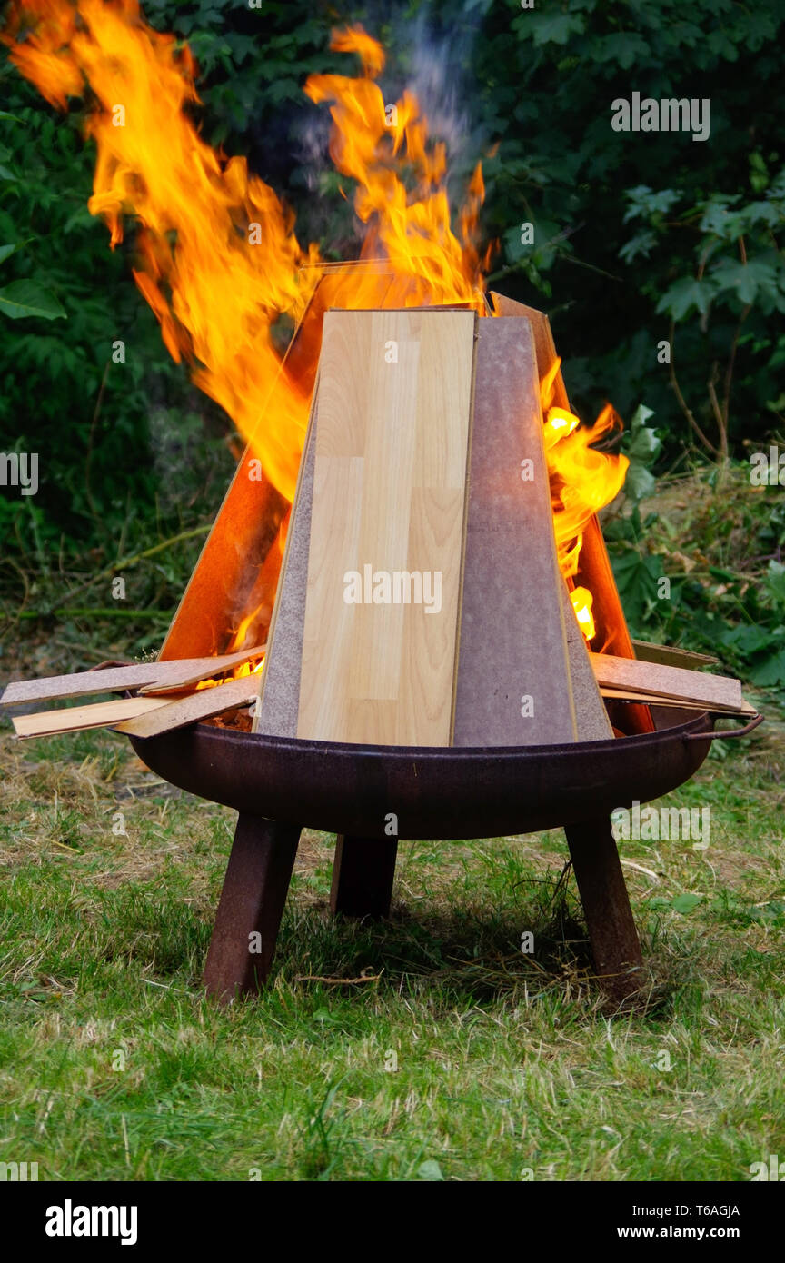 burning Laminate panels in open fire on a grill place Stock Photo