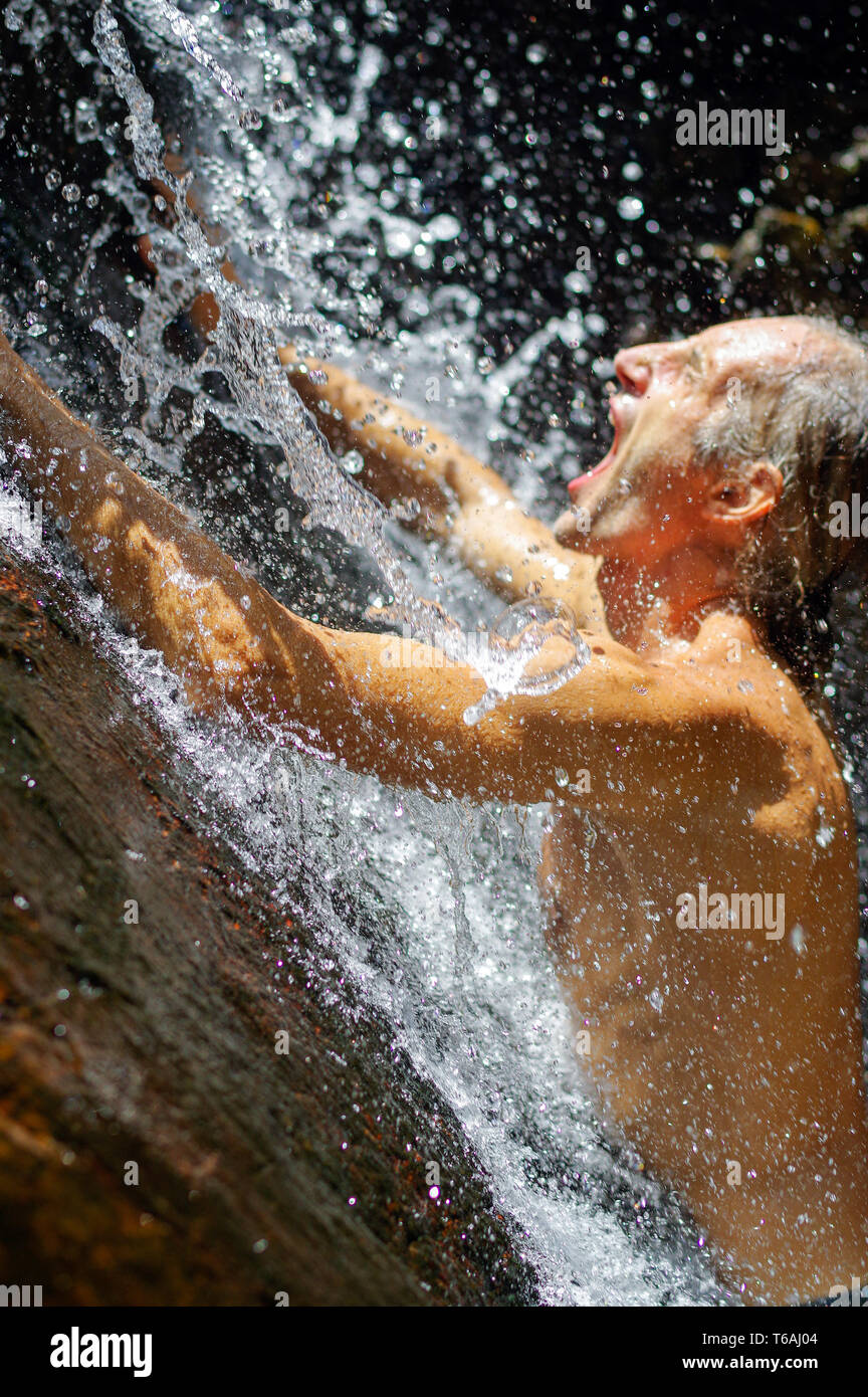 Man bathing under waterfall hires stock photography and images Alamy