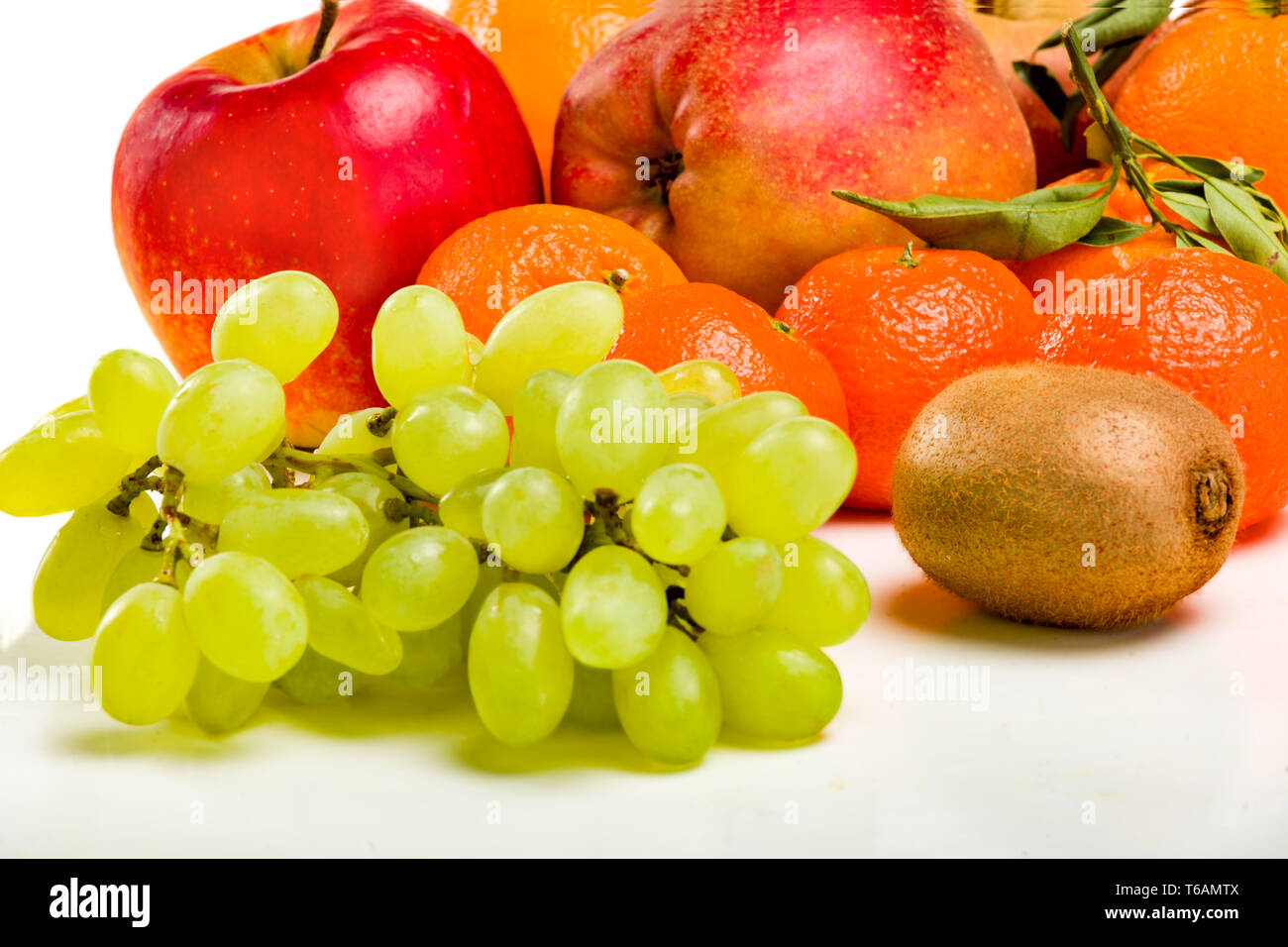 Fresh juicy fruit bunches of grapes, mandarin, apple Stock Photo Alamy