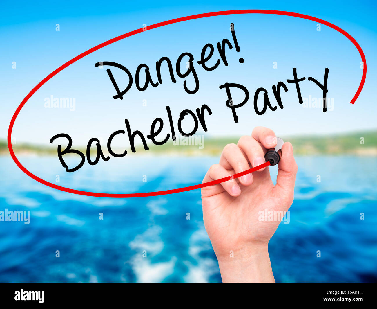 Man Hand writing Danger! Bachelor Party with black marker on visual screen Stock Photo