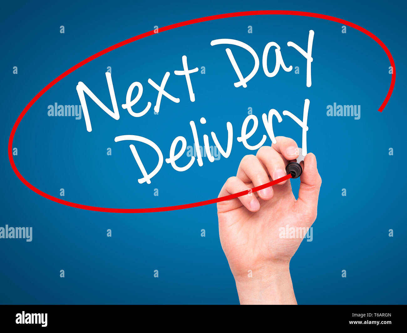 Man Hand writing Next Day Delivery with black marker on visual screen