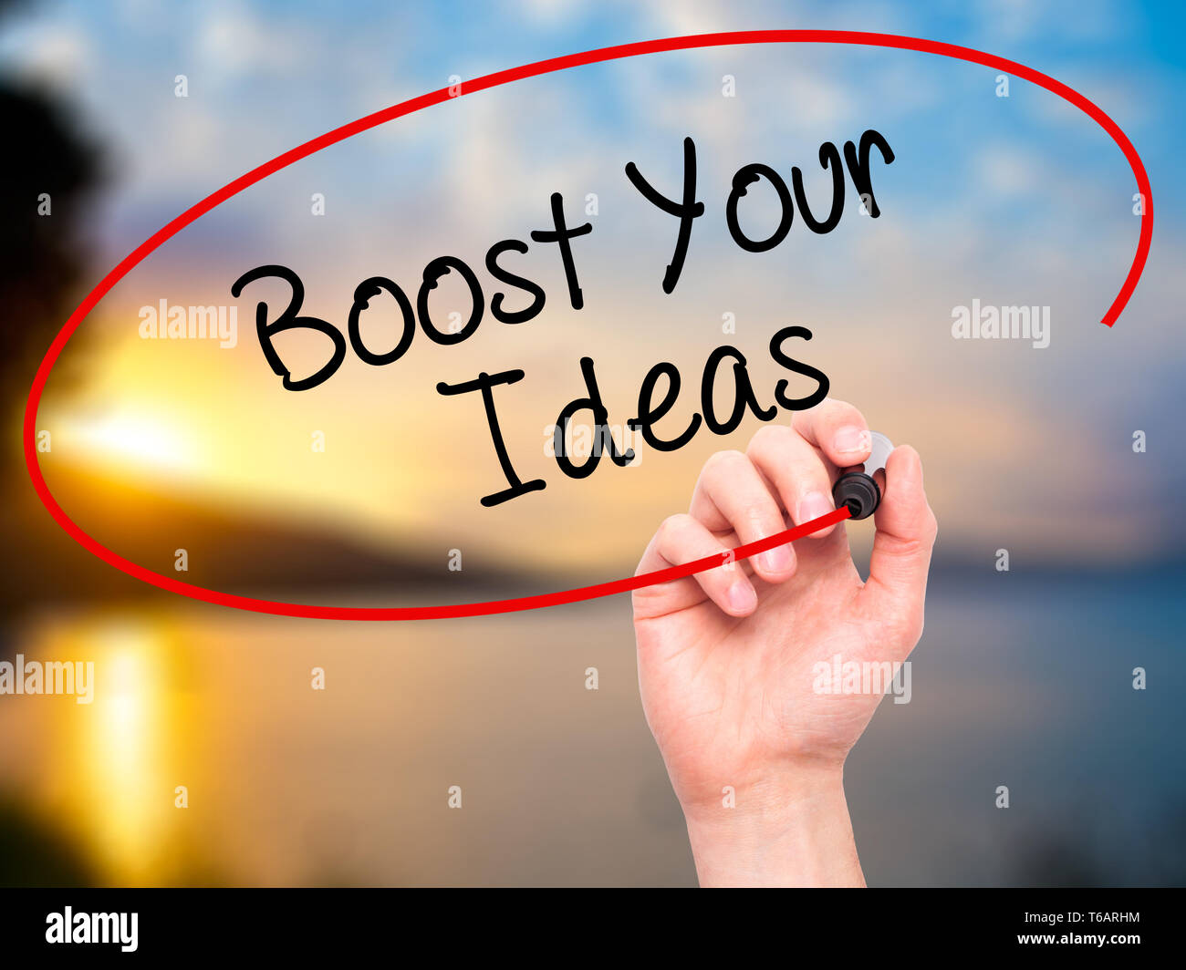 Man Hand writing Boost Your Ideas with black marker on visual screen ...