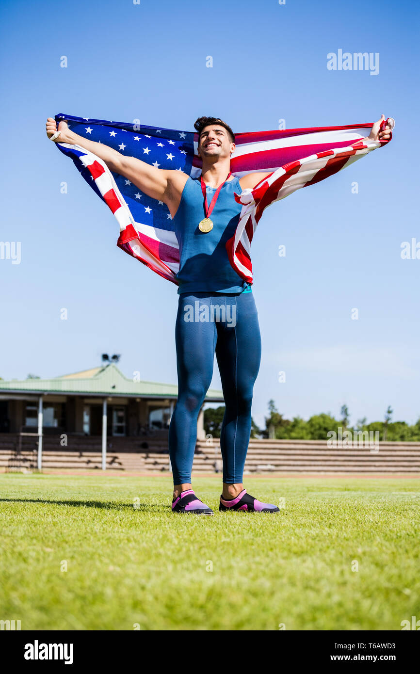 Athlete posing with american flag and gold medals around his neck Stock ...