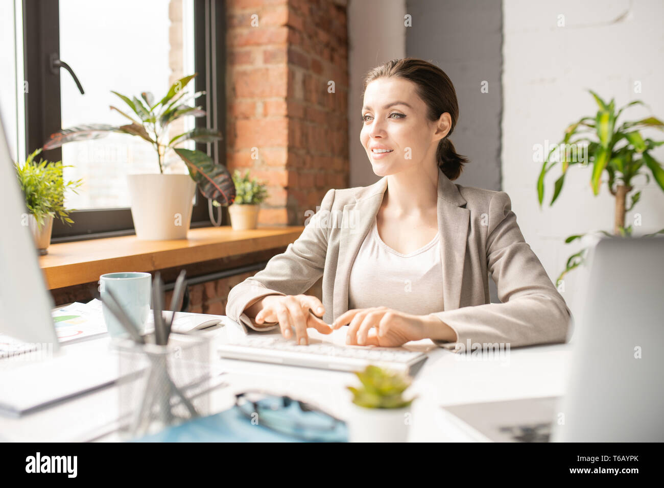 Typing in front of monitor Stock Photo Alamy