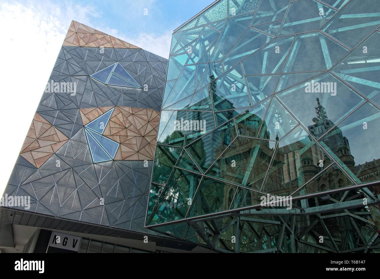 Melbourne, Australia - Forum Theatre and city skyline reflected in Federation Square glass Stock Photo