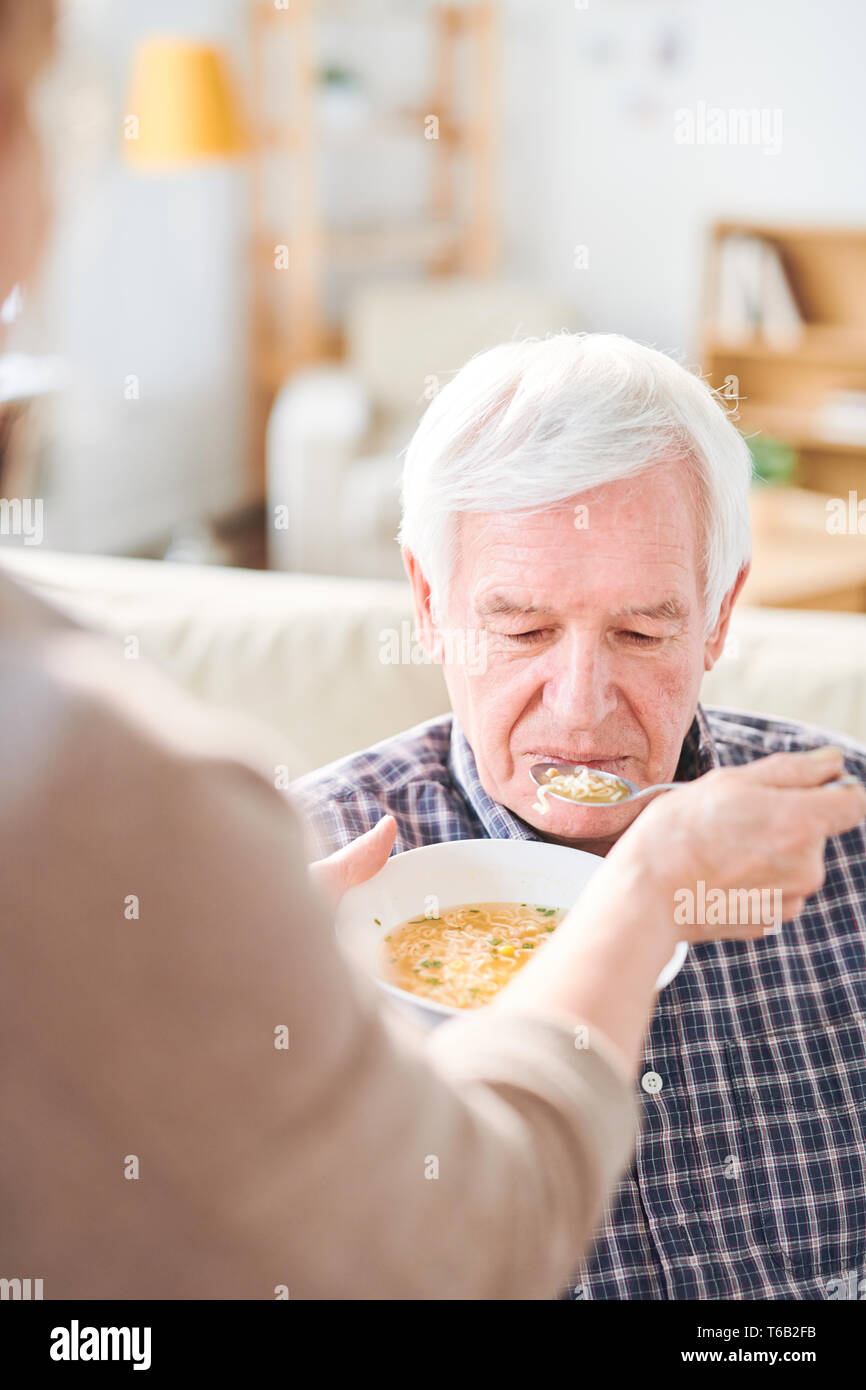 Feeding disable man with soup Stock Photo