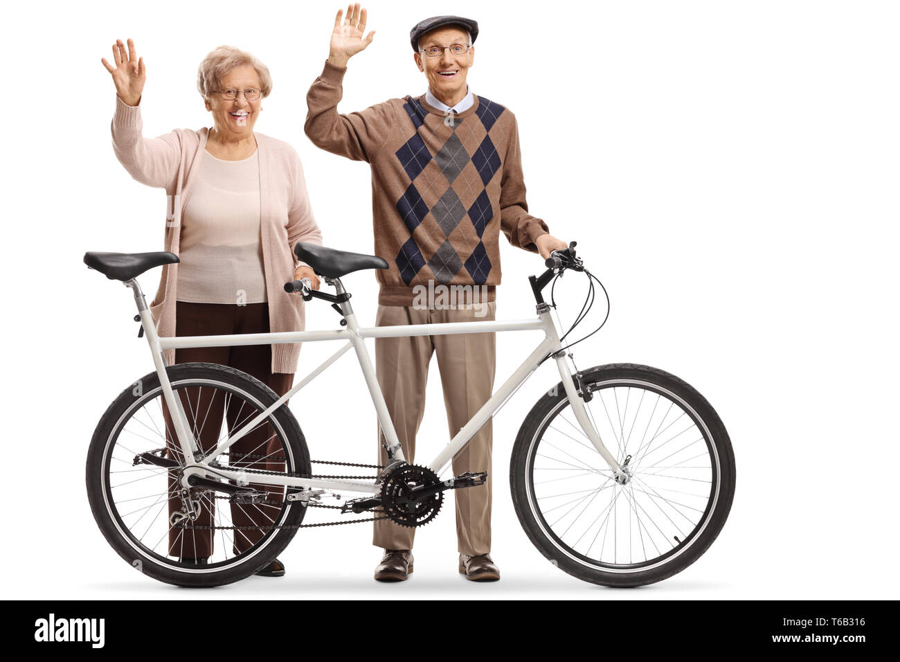 Full length portrait of an elderly couple of a man and woman with a tandem bicycle waving isolated on white background Stock Photo