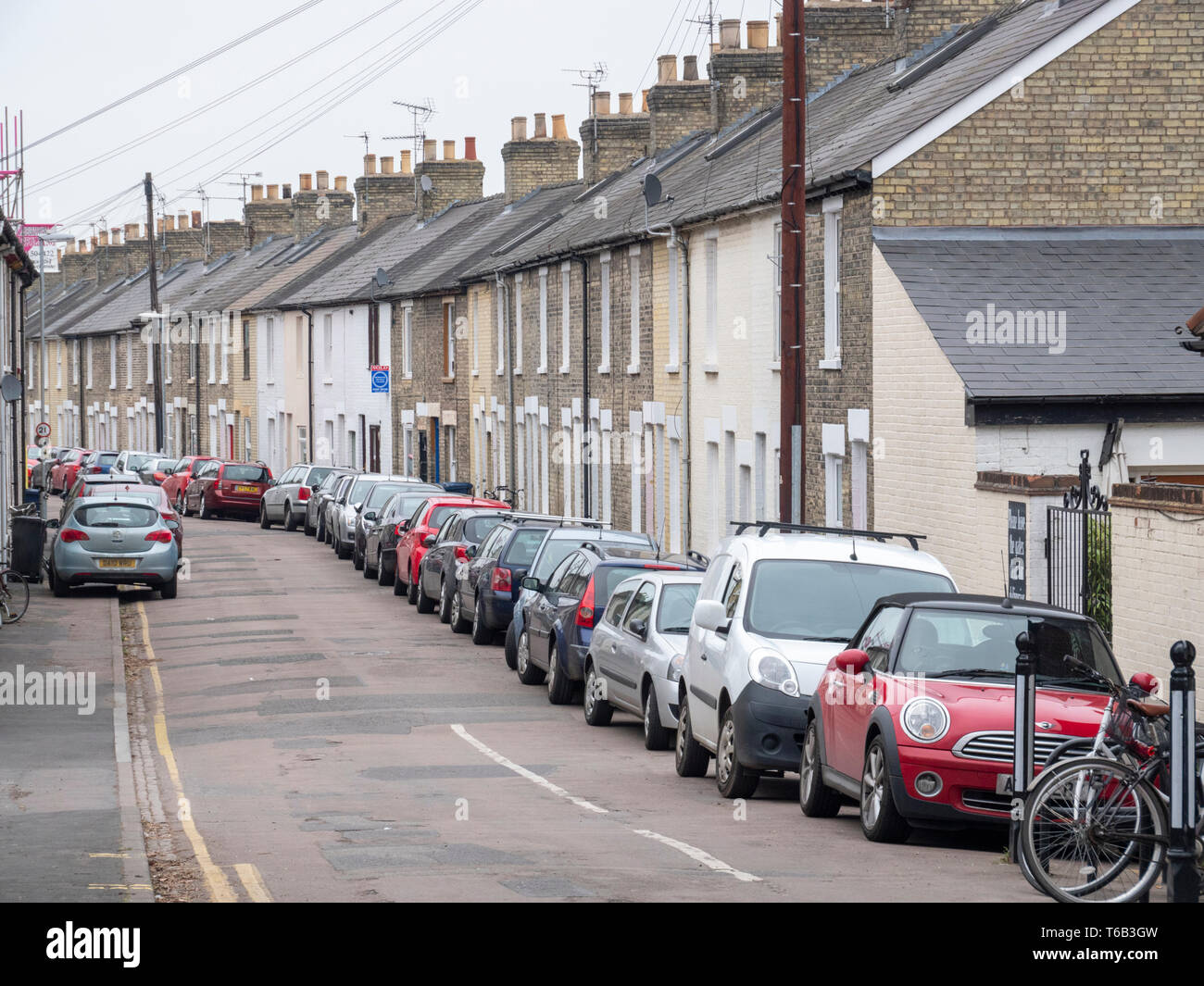 A view of a street in Cambridge UK with cars parked on the road and