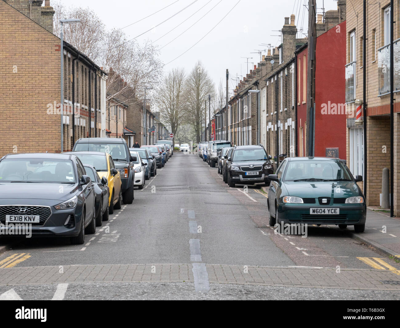 A view of a street in Cambridge UK with cars parked on the road and