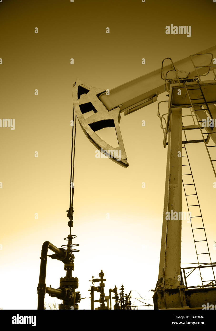Oil pump jack and wellhead in the oilfield Stock Photo Alamy