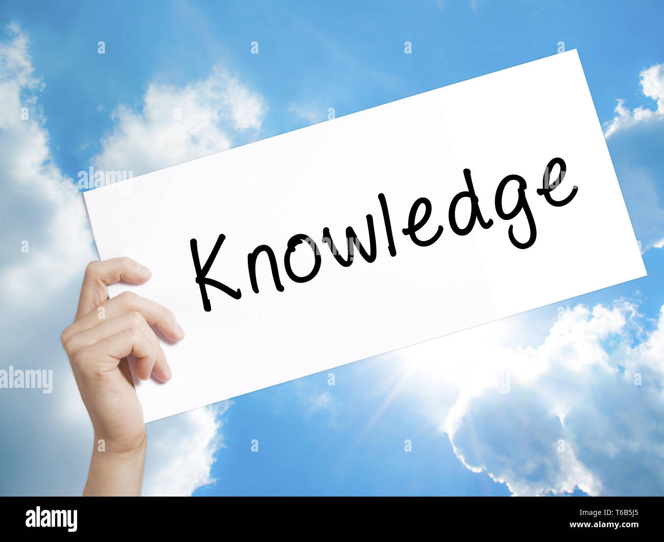 Knowledge Sign on white paper. Man Hand Holding Paper with text