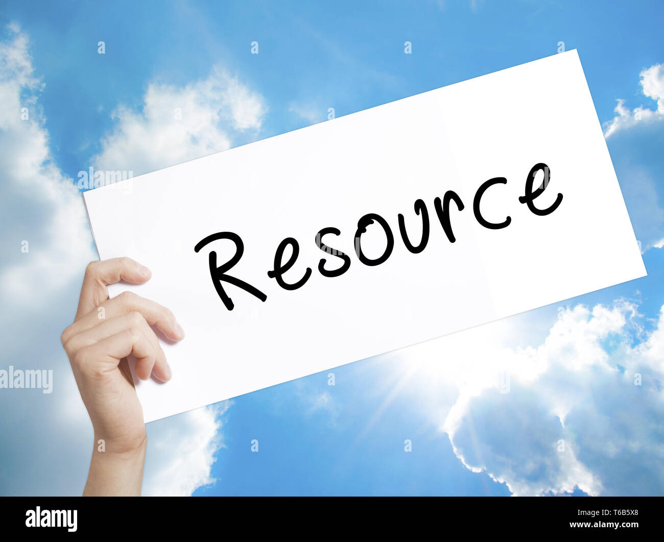 Resource Sign on white paper. Man Hand Holding Paper with text. Isolated on sky background Stock Photo