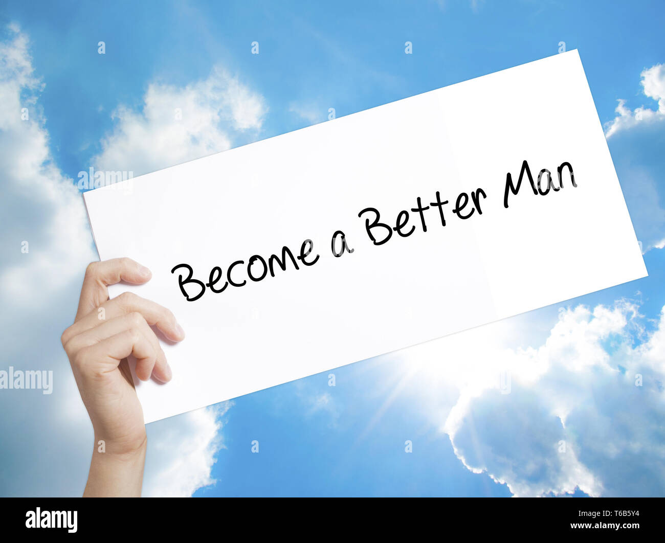 Become a Better Man Sign on white paper. Man Hand Holding Paper with text. Isolated on sky background Stock Photo