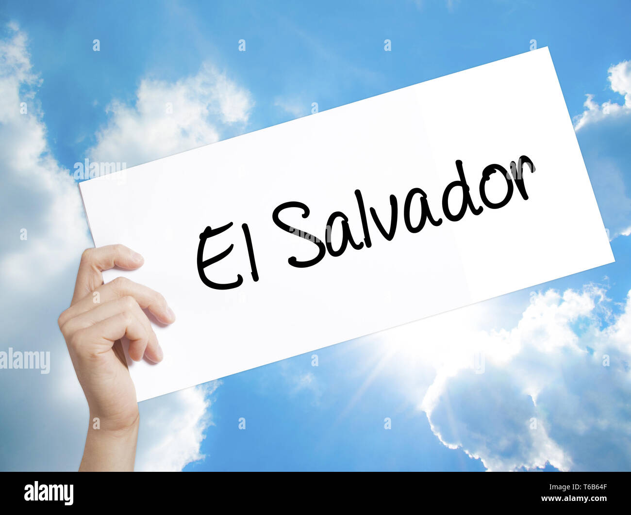 El Salvador Sign on white paper. Man Hand Holding Paper with text. Isolated on sky background Stock Photo