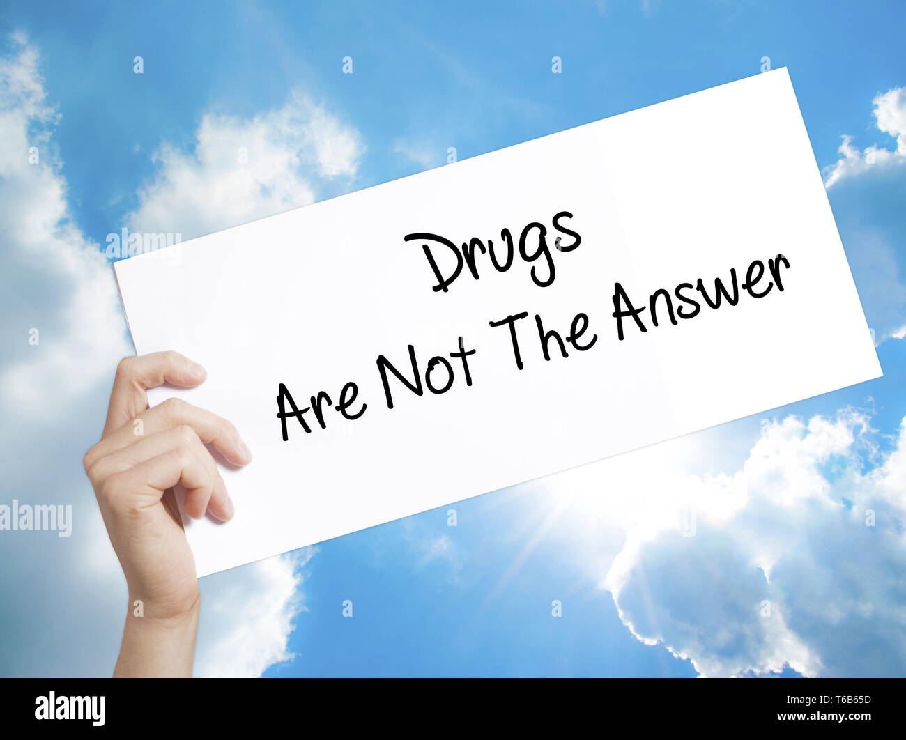 Drugs Are Not The Answer Sign on white paper. Man Hand Holding Paper